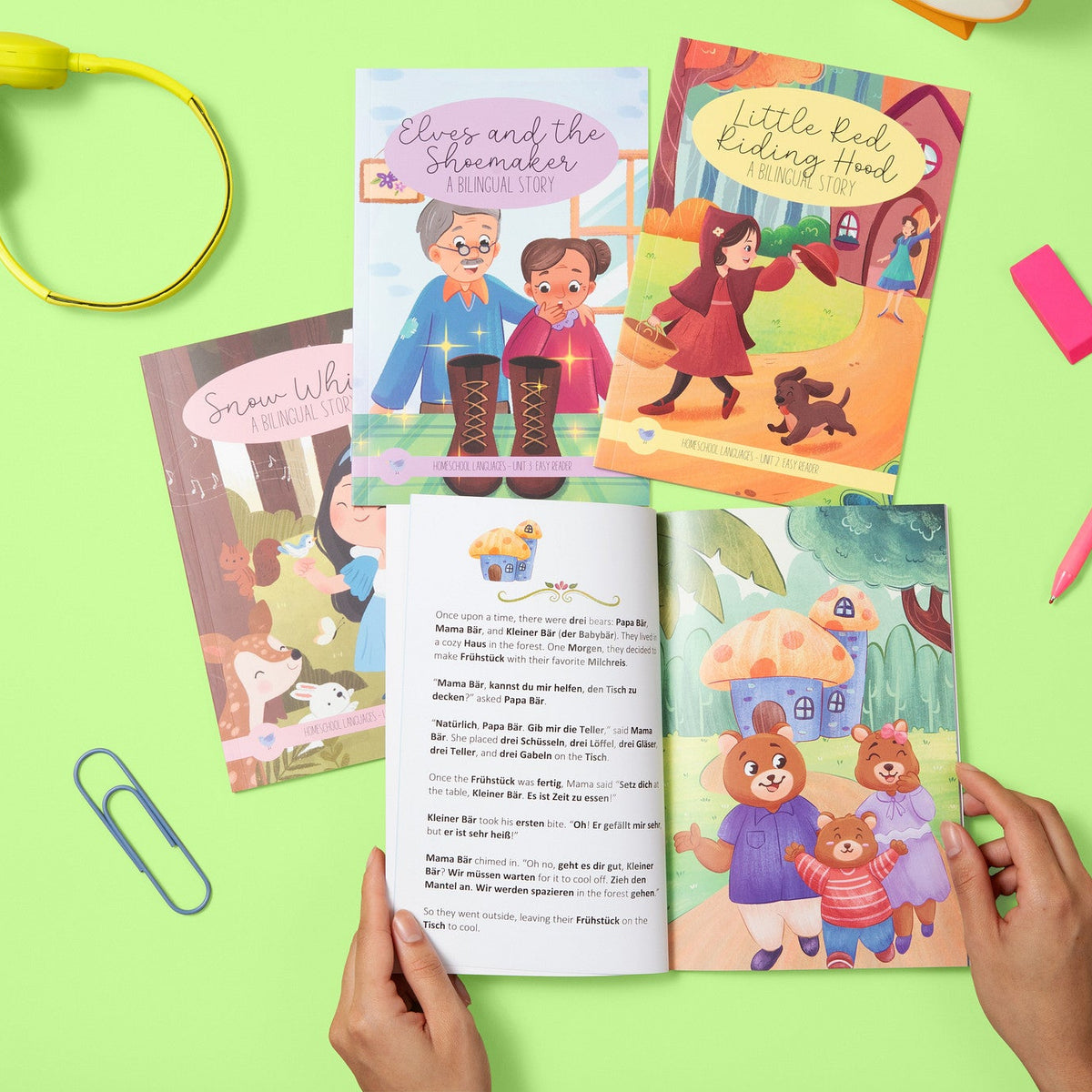 Children's books on a green background with hands holding an open book.